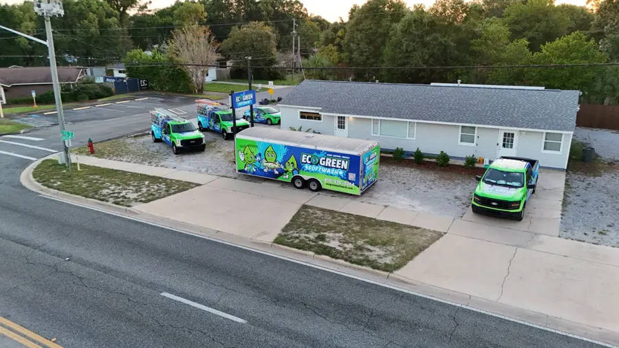 Eco Green Softwash trucks and trailer outside the shop